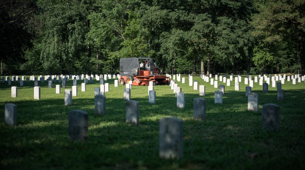 Cemetery lawn equipment near flat grave markers